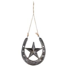 a metal star hanging from a rope on a white background, with the shape of a horseshoe