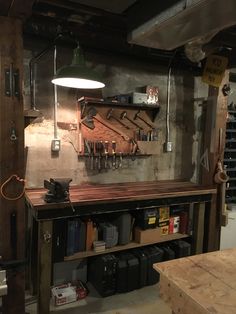 a workbench with lots of tools hanging on the wall