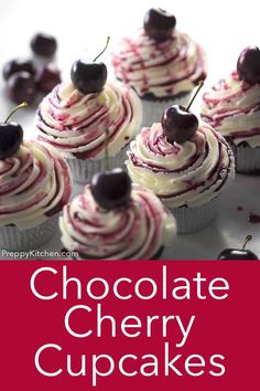 chocolate cherry cupcakes with white frosting and cherries on top, in front of