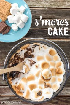 there is a cake with marshmallows in it and the words s'mores cake above it