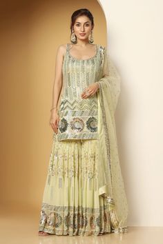 Light green sleeveless padded short kurta in georgette base with metallic sequin vines, chevron and floral swirl embroideries. Paired with a sequin garden embellished tiered sharara and ditsy sequin motif embellished net dupatta. - Aza Fashions Green Sleeveless Dress For Diwali, Green Sleeveless Lehenga For Summer, Sleeveless Green Palazzo Set For Wedding, Sleeveless Green Salwar Kameez With Dupatta, Green Sleeveless Palazzo Set For Festive Occasions, Sleeveless Pista Green Designer Sets, Traditional Pista Green Sleeveless Sets, Pista Green Sleeveless Traditional Sets, Pista Green Sleeveless Sets For Festive Occasion