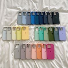 six different colors of cell phones on a white sheet with the same phone in each case