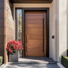 the front entrance to a modern home with flowers