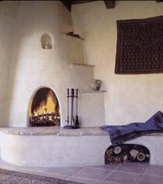 a room with a fireplace and rugs on the floor