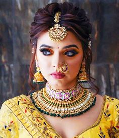 a woman with makeup and jewelry on her face