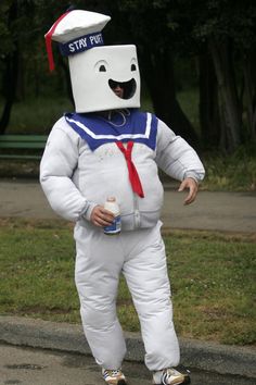 a man in a costume standing on the street