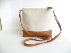 "Vegan leather and natural linen simple everyday casual cross body bag in beige and cognac brown color. *Exterior: - Bottom - high quality vegan leather in gorgeous cognac brown tan color. - Top - natural organic linen. * Interior - Fully lined with floral print natural cotton in shades of brown and beige. * Two inside slip pocket for daily belongings like phone, keys, etc. * Additionally lined for better structure. * YKK metal zipper closure * Detachable leather strap * Caramel brown vegan leat Messanger Bag, Crossbody Leather Bag, Casual Tote Bag, Leather Tote Purse, Vegan Leather Tote, Brown Leather Totes, Vegan Leather Bag, Brown And Beige, Crossbody Messenger Bag