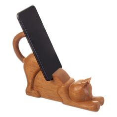 a wooden phone holder with a cat on it's side and a black tablet in the back