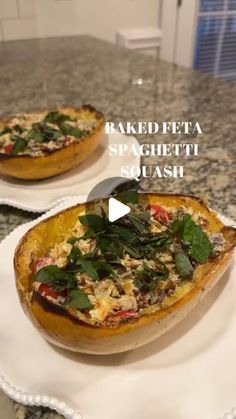 baked feta spaghetti squash with spinach and red peppers on a white platter