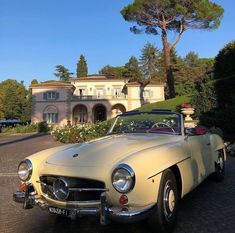 an old car parked in front of a house