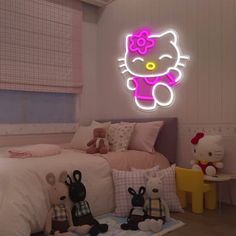 a hello kitty neon sign above a bed in a bedroom