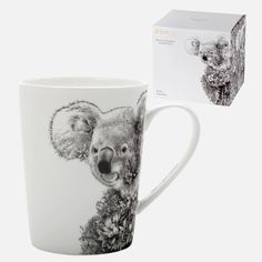 a coffee mug with a koala on it and a box for the package in front