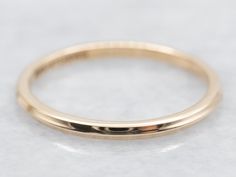 This simple gold band is so versatile! Wear it as a wedding ring, create a ring stack, or wear it alone for a chic minimalist look. A nice detail is the knife edge profile that creates a subtle play of light! Metal: 14K Yellow Gold Width of Band: 1.5 mm Height off Finger: 1.6 mm Ring Size: 6 Marks: "14KARTCARVED" Stamped on the inside band SKU #: A45671 Each piece has been identified and graded by a Graduate Gemologist who has been certified by the Gemological Institute of America (GIA). We have six brick-and-mortar storefronts in Maine, Massachusetts, and New Hampshire and have been in business for over 25 years! Please visit our Shop's About Page or our website for more information about our jewelry. For questions about diamond grading, we recommend the  Gemological Institute of America Simple Gold Band, Edge Profile, Band Art, Gold Armband, Ring Wedding Band, Ring Stack, Art Carved, Stacking Ring, Ring Wedding