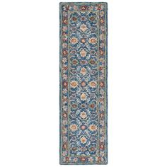 a blue and red rug with an ornate design on the bottom, in front of a white background