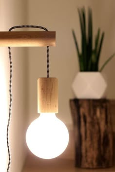 a light that is sitting on top of a table next to a potted plant