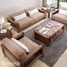 a living room filled with furniture and a large window in the background on top of a hard wood floor