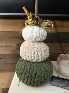 a stack of knitted pillows sitting on top of each other