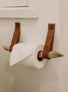 a roll of toilet paper is hanging on the wall