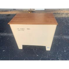 a white and brown table sitting on top of a parking lot