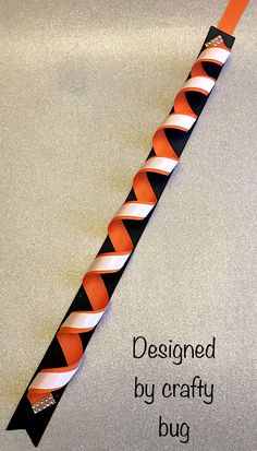 an orange and black striped tie with the words designed by crafty bug on it