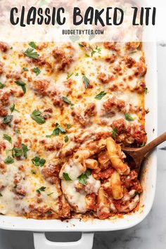 a casserole dish with meat and cheese in it, topped with parsley