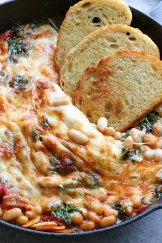 a skillet filled with pasta and bread