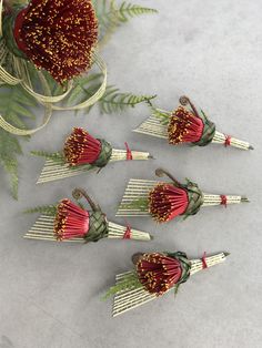 four red and white flowers sitting on top of a table