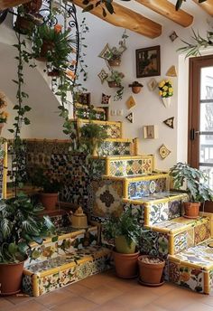 the stairs are decorated with colorful tiles and potted plants