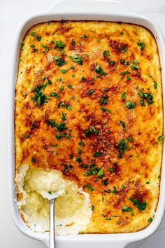 a casserole dish filled with mashed potatoes and garnished with parsley