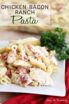 chicken bacon ranch pasta on a white plate with parsley and red napkin in the background