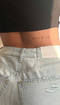 a woman's stomach with the word love tattooed on her lower back and side