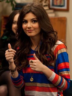 a young woman giving the thumbs up sign