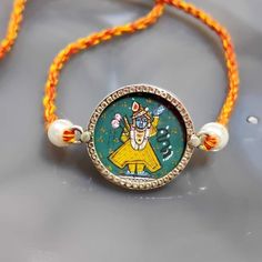 a necklace with an image of the god on it's face and beads around it