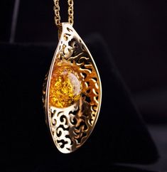 a Baltic Amber Pendant Necklace, Amber Pendant Necklace In Baltic Amber, Gold Baltic Amber Necklace For Gift, Oval Baltic Amber Necklace, Gold Pendant Necklace With Baltic Amber, Baltic Amber Necklace With Round Pendant, Round Baltic Amber Pendant Necklace, Round Pendant Baltic Amber Necklace, Elegant Gold Baltic Amber Necklace