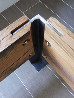 a close up of a piece of wood on the floor next to a door handle