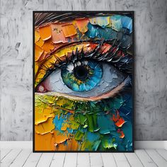 an abstract painting with blue eyes and colorful paint streaks on the bottom half of it