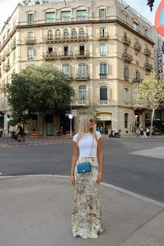 a woman standing in the middle of a street