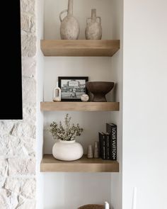 some shelves with vases and books on them