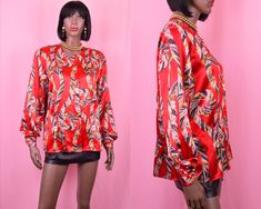 "Beautiful lightweight silky long sleeve red button up blouse with gold baroque print, perfect for a formal evening look. Five gold button closures and thin shoulder pads. Authentic vintage item from the 1990's era.   Flat Measurements: BUST- 22\" SLEEVES- 25\" LENGTH- 26\" Fits size: LARGE Tag Size: 12 Brand: Martinique Excellent condition. Shop our entire blouse collection below: https://www.etsy.com/shop/vintagealleyshop/?section_id=16181985" Red Satin Blouse, Baroque Print, Gold Baroque, Dressy Blouse, Satin Shirt, Red Button, Button Up Top, Satin Blouse, Red Satin