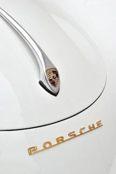 porsche emblem on the front of a white car