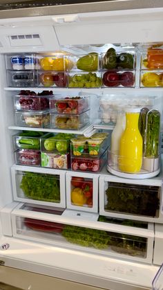 an open refrigerator filled with lots of different types of vegetables and fruit in it's doors