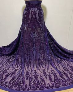 "Exclusive Purple Bridal Sequin Lace/ Stretch Purple Sequins Fabric/ Purple Sequins on Purple Stretch Mesh/ 4 Way Stretch Purple Sequin- By Piece This beautiful Stretch Purple Mesh Fabric embroidery with Purple sequins. sale by yard and 54\" width . It is ideal for costumes, dance, dress & special occasions. Sequins: 100% polyester sequins Mesh: 92% Polyester & 8% spandex; 4 Way Stretch Mesh Color: Stretch Purple Mesh & Purple Sequins Embroidery Width: 50\" Sold By: 1.5 Yards Usage: High end Afr Purple Lace Prom Evening Dress, Sequin Fabric For Wedding Prom Season, Fitted Sequin Tulle Evening Dress, Fitted Tulle Evening Dress With Sequins, Purple Lace Evening Dress For Party, Wedding Sequin Dress With Contrast Sequin Fitted, Wedding Sequin Dress For Party Season, Fitted Tulle Sequin Dress For Prom Season, Wedding Fitted Sequin Dress With Contrast Sequin