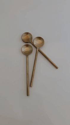 three wooden spoons sitting next to each other