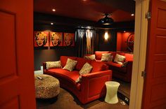 a red couch sitting in the middle of a living room