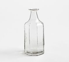 an empty glass bottle on a white background