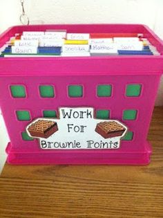 a pink plastic box with brownie points on it's sides and words that spell work for brownie points