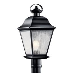 a black post light with two lights on it