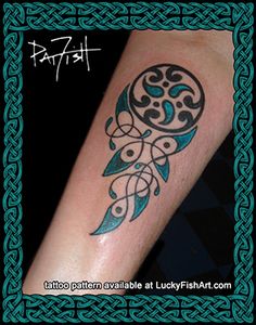 a tattoo on the arm of a woman with an ornamental design in blue and black