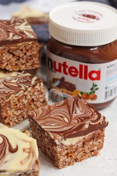 nutella bars with chocolate frosting and peanut butter spread on the top, sitting next to each other