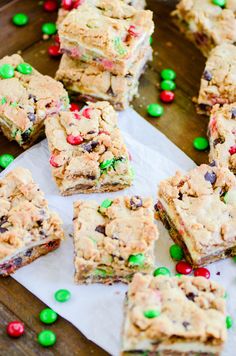 cookies and candy bars are on top of white paper with green and red candies